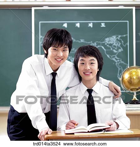 Picture - two students in uniform with putting arms around each other's shoulder. Fotosearch