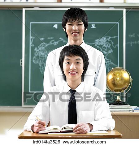 Two students standing in a row View Large Photo Image Stock Photograph - Two students standing in a row. Fotosearch