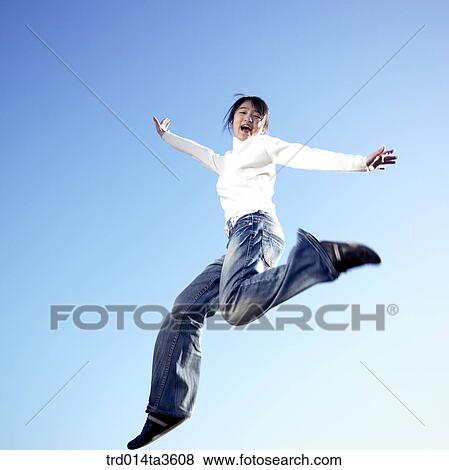 Girl jumping with joy View Large Photo Image Stock Photo - Girl jumping with joy. Fotosearch