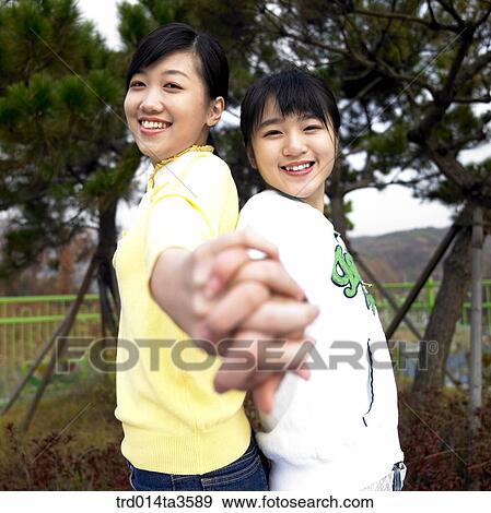 Stock Photo - Girls with hand in hand. Fotosearch