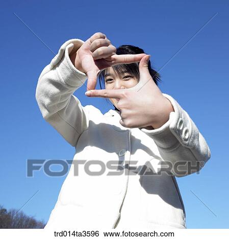 Student in white jumper making hand gesture View Large Photo Image Stock Photograph - Student in white jumper making hand gesture. Fotosearch