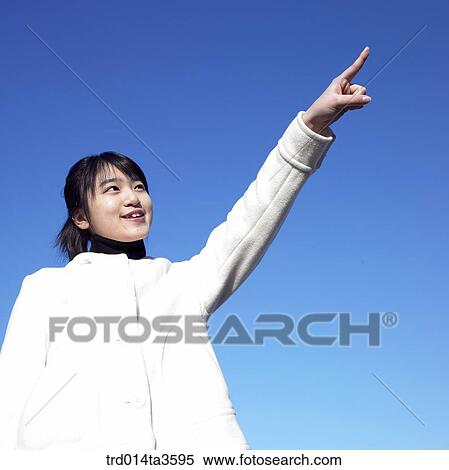 Student in wihte jumper ponitng at sky View Large Photo Image Stock Photography - Student in wihte jumper ponitng at sky. Fotosearch