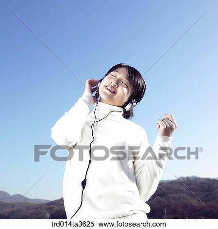 Teen girl listening music with her headset View Large Photo Image Stock Photography - Teen girl listening music with her headset. Fotosearch
