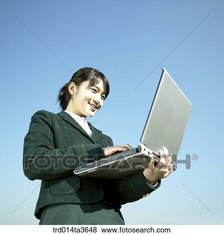 Teen girl using notebook computer View Large Photo Image Stock Photo - Teen girl using notebook computer. Fotosearch