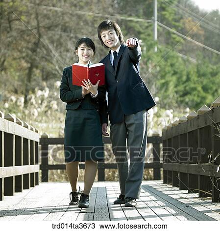 Teen girl using notebook computer with leanning wooden bridge View Large Photo Image Stock Image - Teen girl using notebook computer with leanning wooden bridge. Fotosearch
