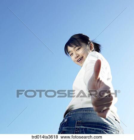 Teen girl with smile making thumb up View Large Photo Image Stock Photo - Teen girl with smile making thumb up. Fotosearch