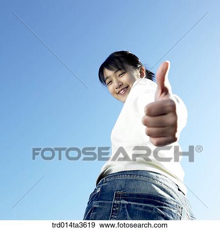 Stock Photo - Teen girl with smile making thumb up. Fotosearch