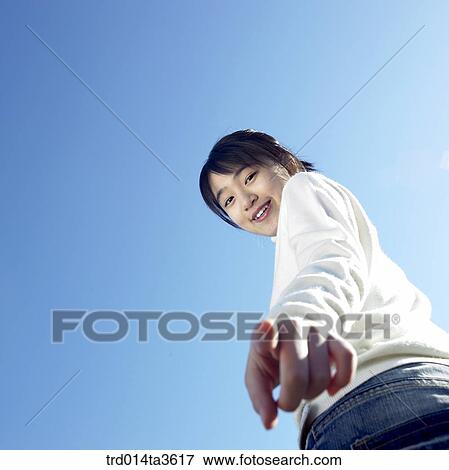 Teen girl with smile poinging at ground View Large Photo Image Stock Photo - Teen girl with smile poinging at ground. Fotosearch