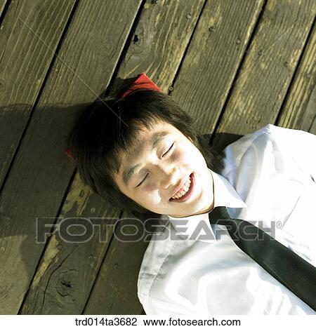 Stock Image - Teen laying down . Fotosearch