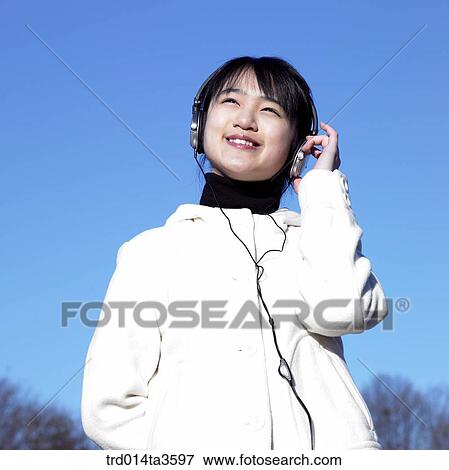 Teen listening musinc with her mp3 player View Large Photo Image Stock Photo - Teen listening musinc with her mp3 player. Fotosearch