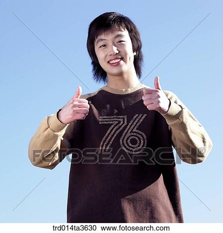 Teen making two thumbs up View Large Photo Image Stock Image - Teen making two thumbs up. Fotosearch