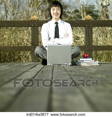 Teen using notebook computer at the bridge View Large Photo Image Stock Photo - Teen using notebook computer at the bridge. Fotosearch