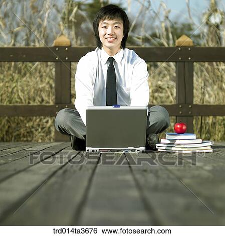 Teen using notebook computer at the bridge View Large Photo Image Stock Photograph - Teen using notebook computer at the bridge. Fotosearch