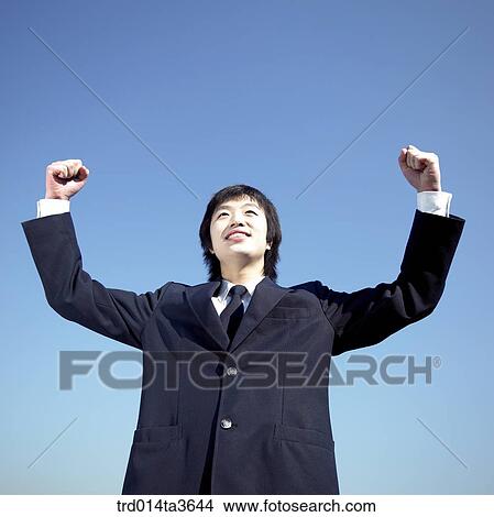Teen with two hands up for his resolution View Large Photo Image Picture - Teen with two hands up for his resolution. Fotosearch