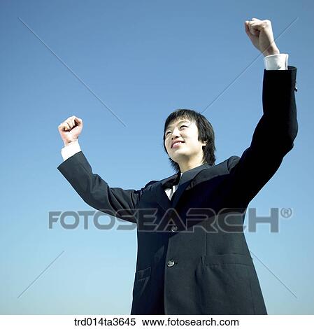 Stock Photography - Teen with two hands up for his resolution. Fotosearch