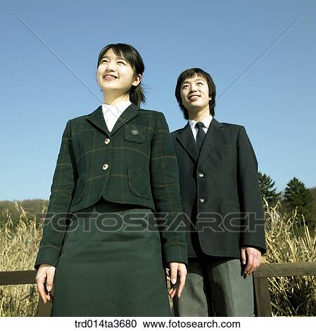Teens in school uniform lookings at same direction View Large Photo Image Stock Image - Teens in school uniform lookings at same direction. Fotosearch