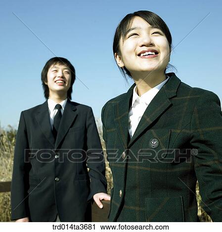 Teens in school uniform lookings at same direction View Large Photo Image Stock Image - Teens in school uniform lookings at same direction. Fotosearch