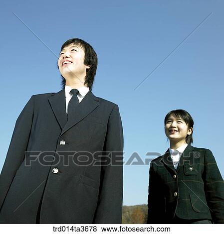Teens in school uniform lookings at same direction View Large Photo Image Stock Photo - Teens in school uniform lookings at same direction. Fotosearch