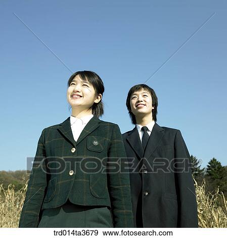 Stock Photo - Teens in school uniform lookings at same direction. Fotosearch