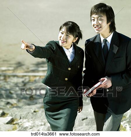 Teens in uniform going up stairs with pointing at View Large Photo Image Stock Image - Teens in uniform going up stairs with pointing at . Fotosearch