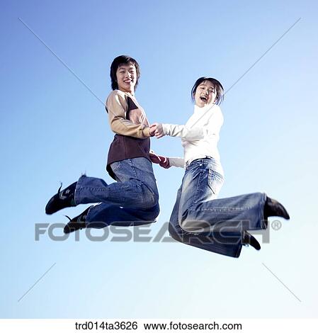 Teens jumping with holding hands View Large Photo Image Stock Photograph - Teens jumping with holding hands. Fotosearch