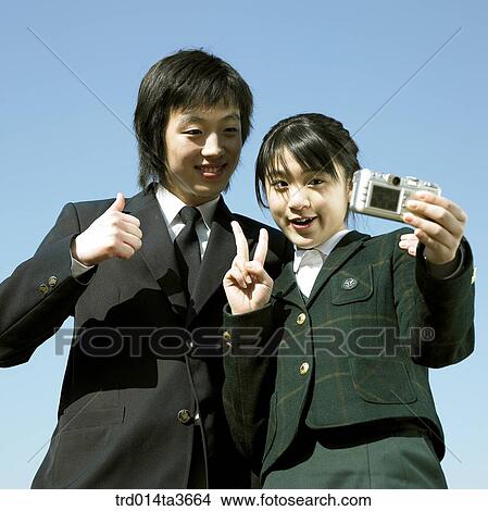 Teens playing with camera and making victory sign View Large Photo Image Picture - Teens playing with camera and making victory sign. Fotosearch