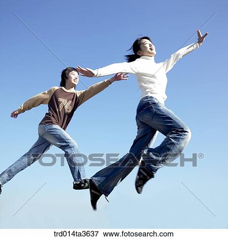 Teens running and jumping at the park View Large Photo Image Stock Photo - Teens running and jumping at the park. Fotosearch