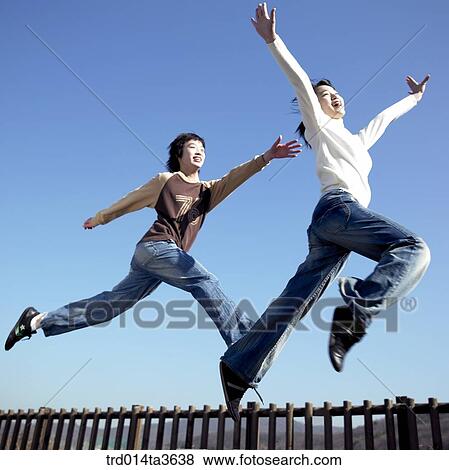 Teens running and jumping at the park View Large Photo Image Stock Photo - Teens running and jumping at the park. Fotosearch