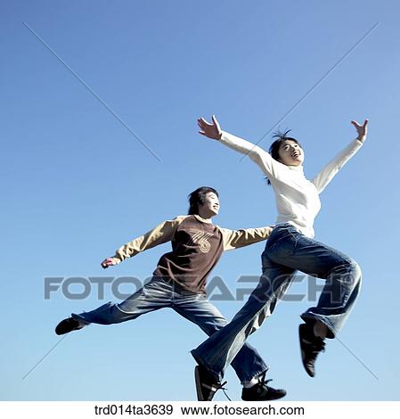 Teens running and jumping at the park View Large Photo Image Stock Photo - Teens running and jumping at the park. Fotosearch