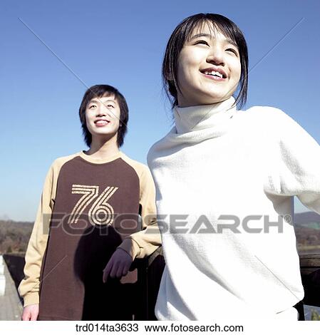 Teens standing near the lake View Large Photo Image Stock Image - Teens standing near the lake. Fotosearch