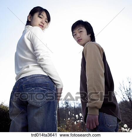 Teens turing and looking at camera View Large Photo Image Stock Image - Teens turing and looking at camera. Fotosearch