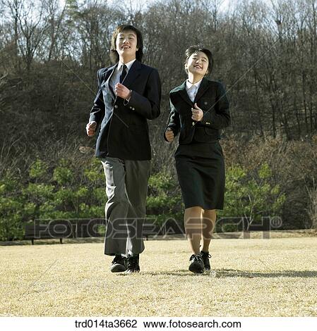 Teens walking fast on the grass View Large Photo Image Stock Image - Teens walking fast on the grass. Fotosearch