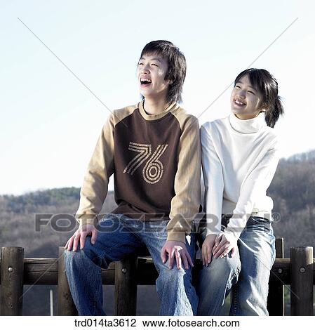 Teens with smile sitting on the fence View Large Photo Image Stock Image - Teens with smile sitting on the fence. Fotosearch