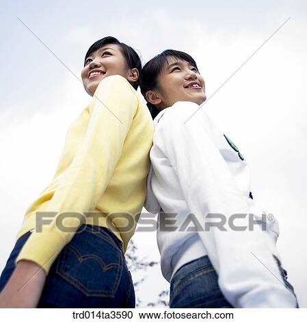 Two girls leaning each other View Large Photo Image Stock Image - Two girls leaning each other. Fotosearch