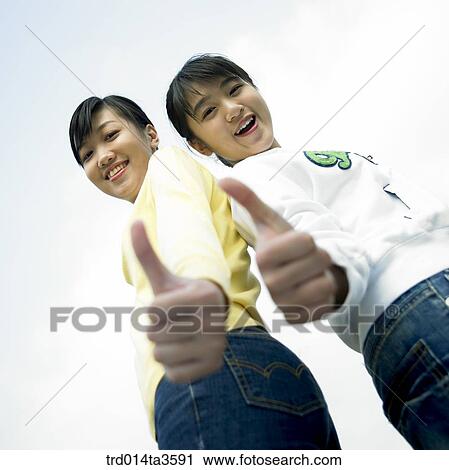 Two girls leaning each other View Large Photo Image Stock Image - Two girls leaning each other. Fotosearch