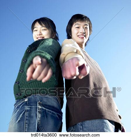 Two Students leaning each other and pointing ground View Large Photo Image Stock Image - Two Students leaning each other and pointing ground. Fotosearch