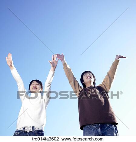 Stock Image - Two studnets cheering up. Fotosearch