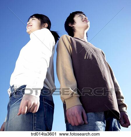 Stock Image - Two studnets standing and looking other side. Fotosearch