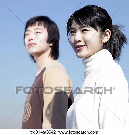 Two teens looking at same direction View Large Photo Image Stock Image - Two teens looking at same direction. Fotosearch