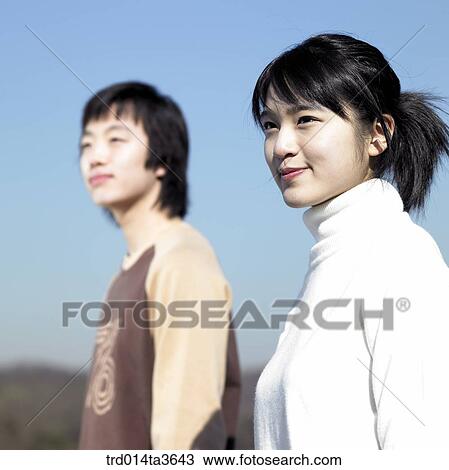 Two teens looking at same direction View Large Photo Image Stock Image - Two teens looking at same direction. Fotosearch