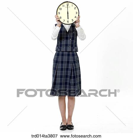 Teen girl holind clock on her face View Large Photo Image Stock Photo - Teen girl holind clock on her face. Fotosearch
