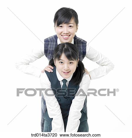 Stock Image - Teen girls putting her arm on her friend's shoulder . Fotosearch