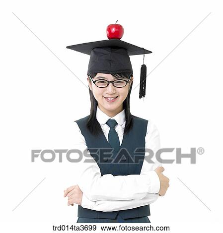 Stock Photo - Teen in school uniform wearing graduation cap. Fotosearch