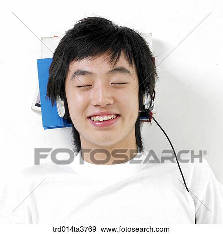 Teen in sellping while listening music View Large Photo Image Stock Photo - Teen in sellping while listening music. Fotosearch