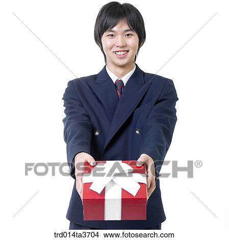 Teen in uniform giving present View Large Photo Image Picture - Teen in uniform giving present. Fotosearch