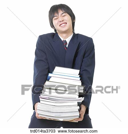 Teen in uniform holding heavy books View Large Photo Image Stock Image - Teen in uniform holding heavy books. Fotosearch