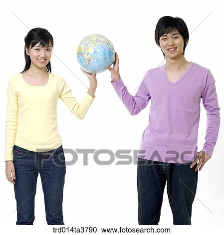 Teens holding the globe View Large Photo Image Stock Image - Teens holding the globe. Fotosearch