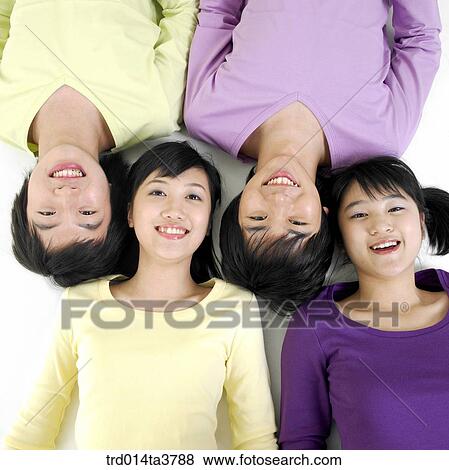 Teens in casual wear laying down View Large Photo Image Stock Photo - Teens in casual wear laying down. Fotosearch