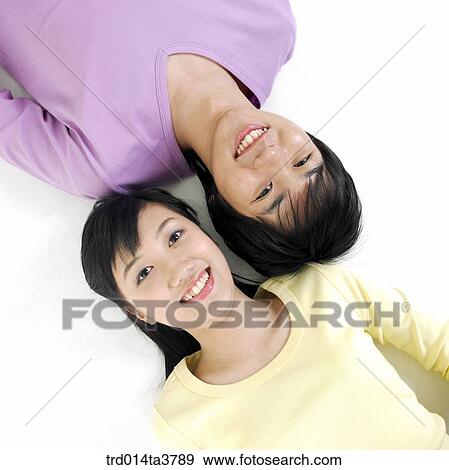 Stock Photo - Teens in casual wear laying down. Fotosearch