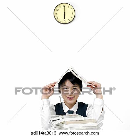 Stock Image - Teens in school uniform staying up night for studying. Fotosearch
